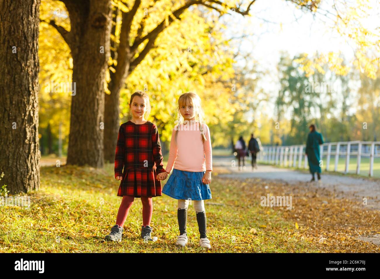 two little girls in autumn park Stock Photo - Alamy