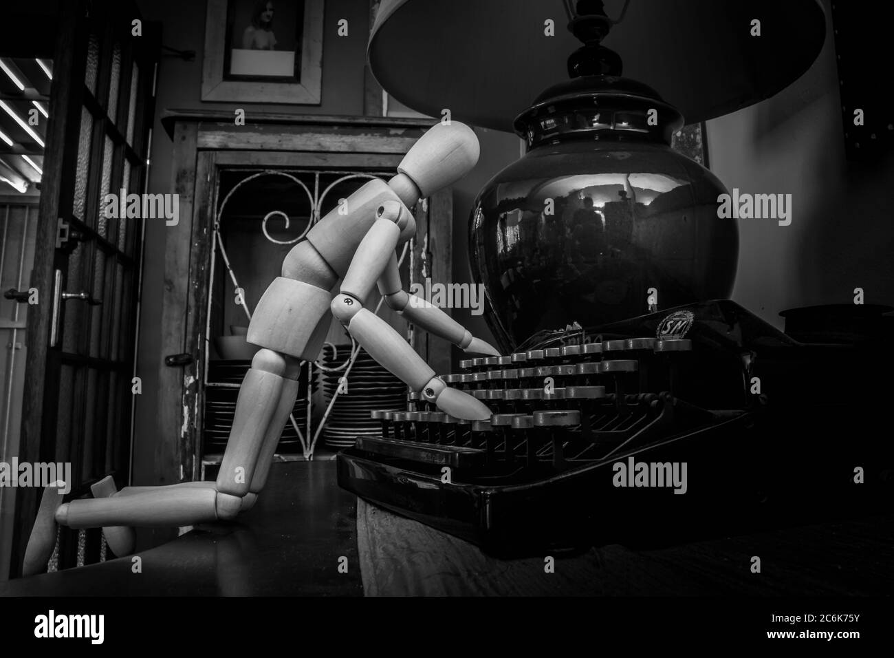 Wooden Human Manikin posing with an antique typewriter Stock Photo Alamy