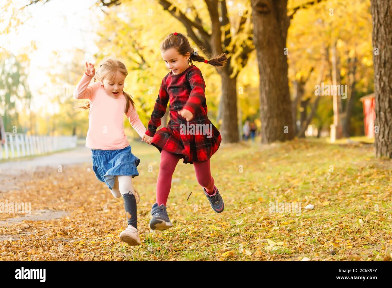two little girls in autumn park Stock Photo - Alamy