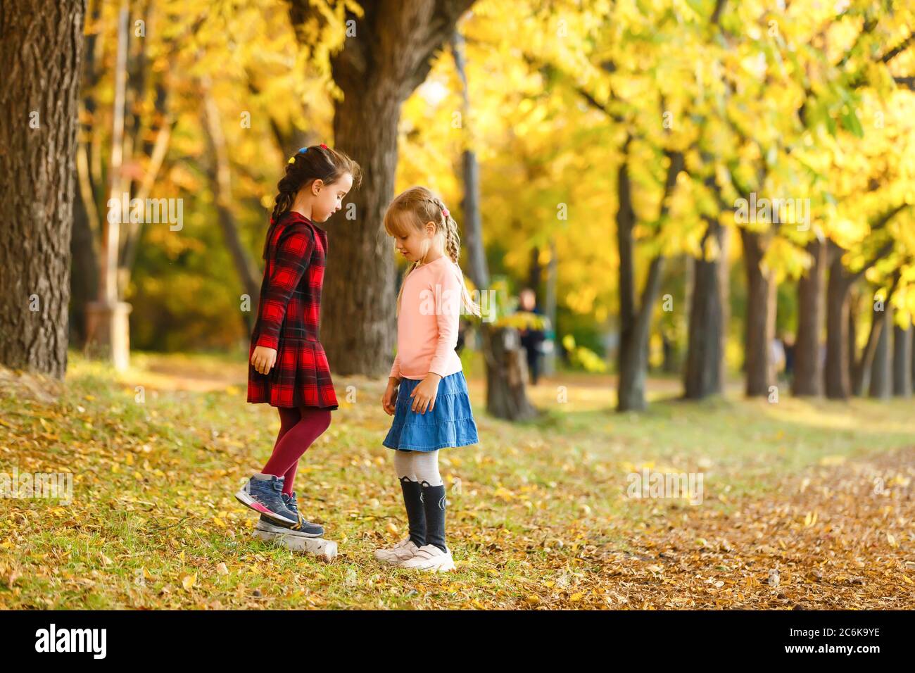 two little girls in autumn park Stock Photo - Alamy