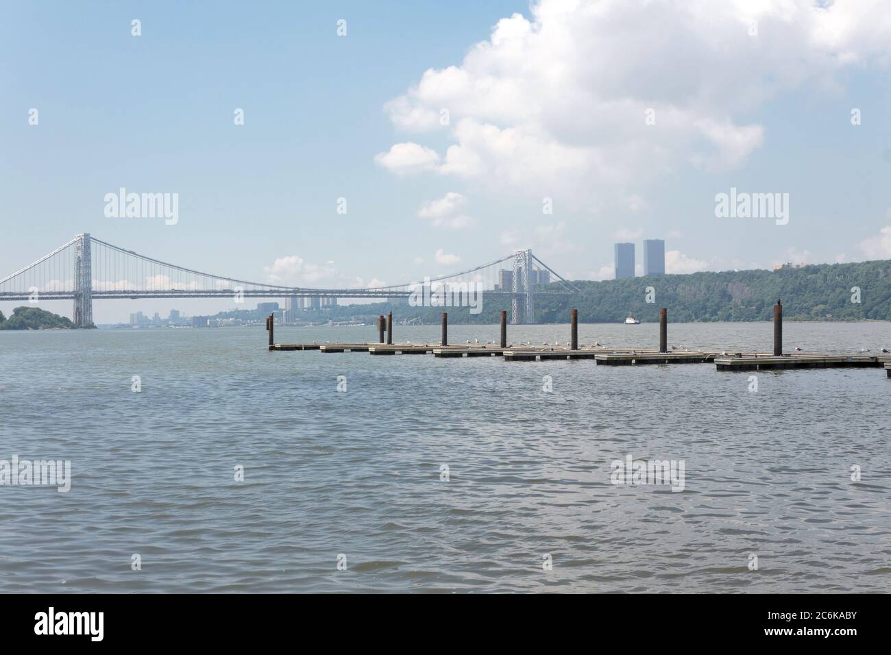the George Washington Bridge from Manhattan side of the Hudson River with boat docks visible in the foreground Stock Photo