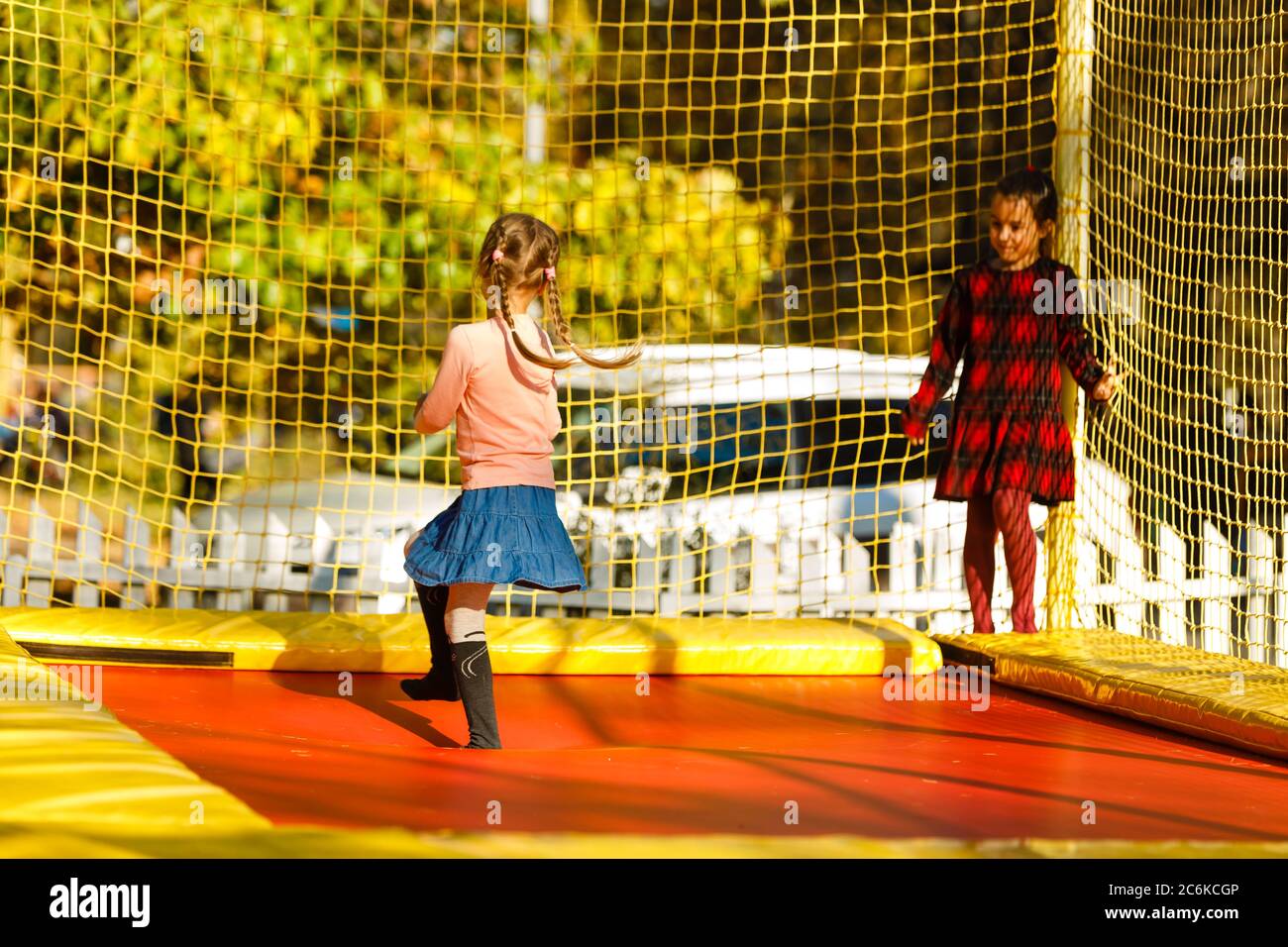 Two girls on a trampoline hi-res stock photography and images - Alamy
