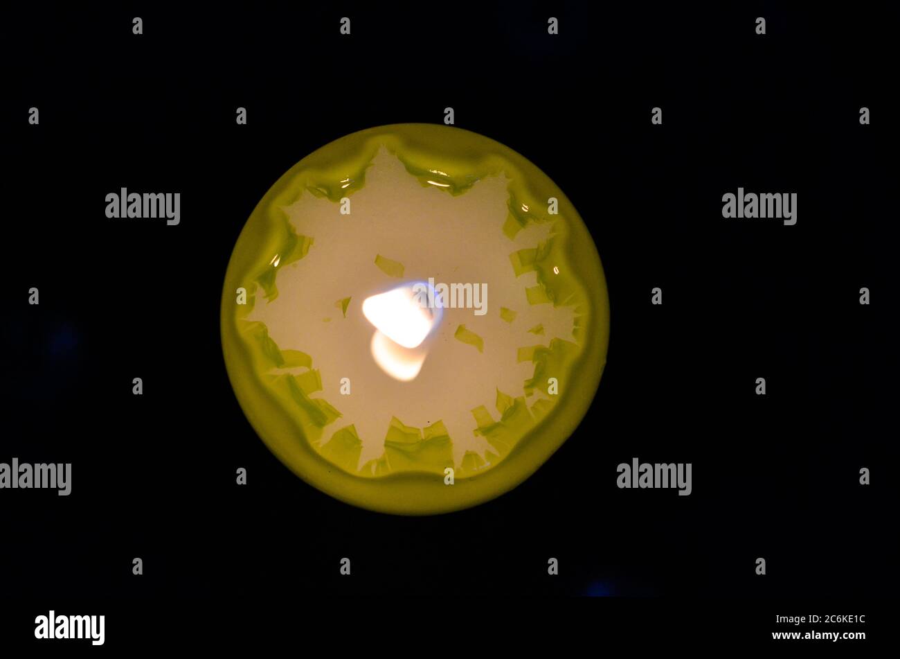 Burning green candle against a black background Stock Photo Alamy