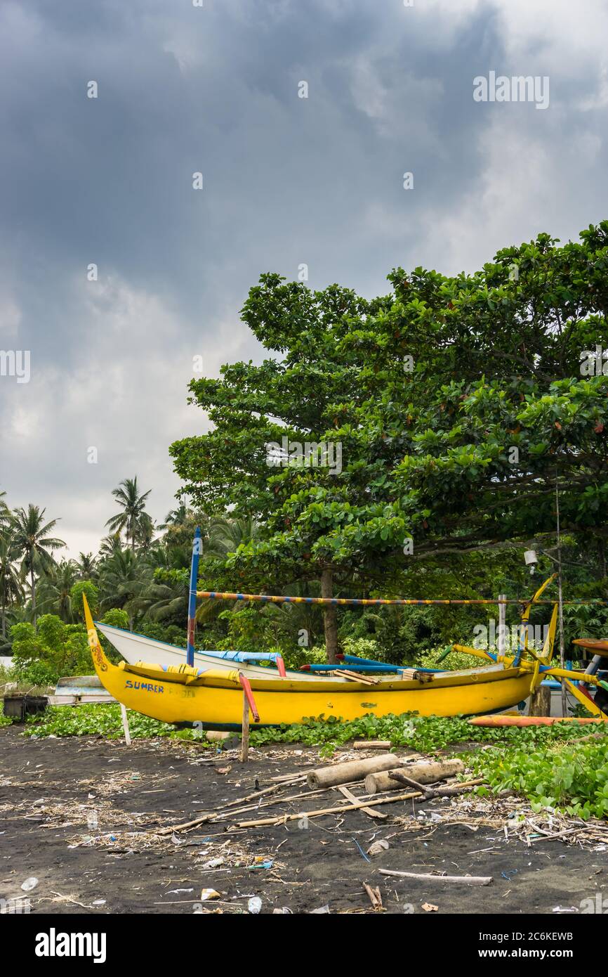 old yellow wooden boat on a tropical beach under a cloudy sky Stock ...