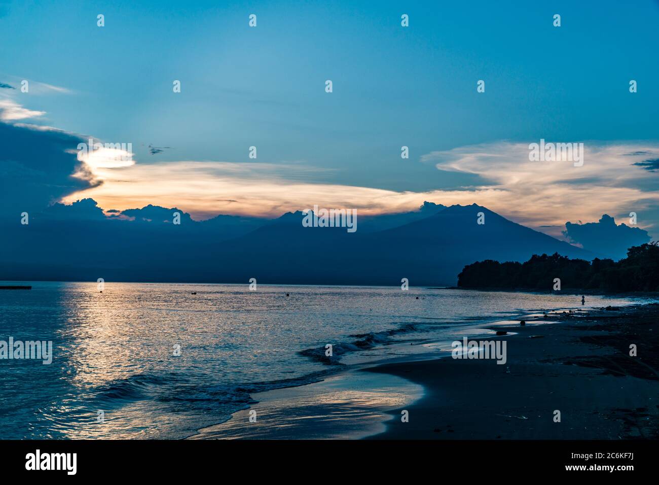 Bali seascape at sunset with blue sky and orange clouds. Java volcano in the background. quiet scenery. lanscape format Stock Photo