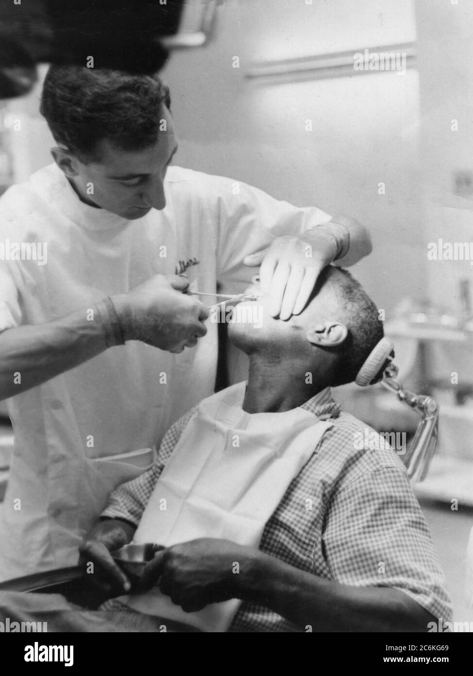 Philadelphia 1960. A dentist attending to a boy. Stock Photo