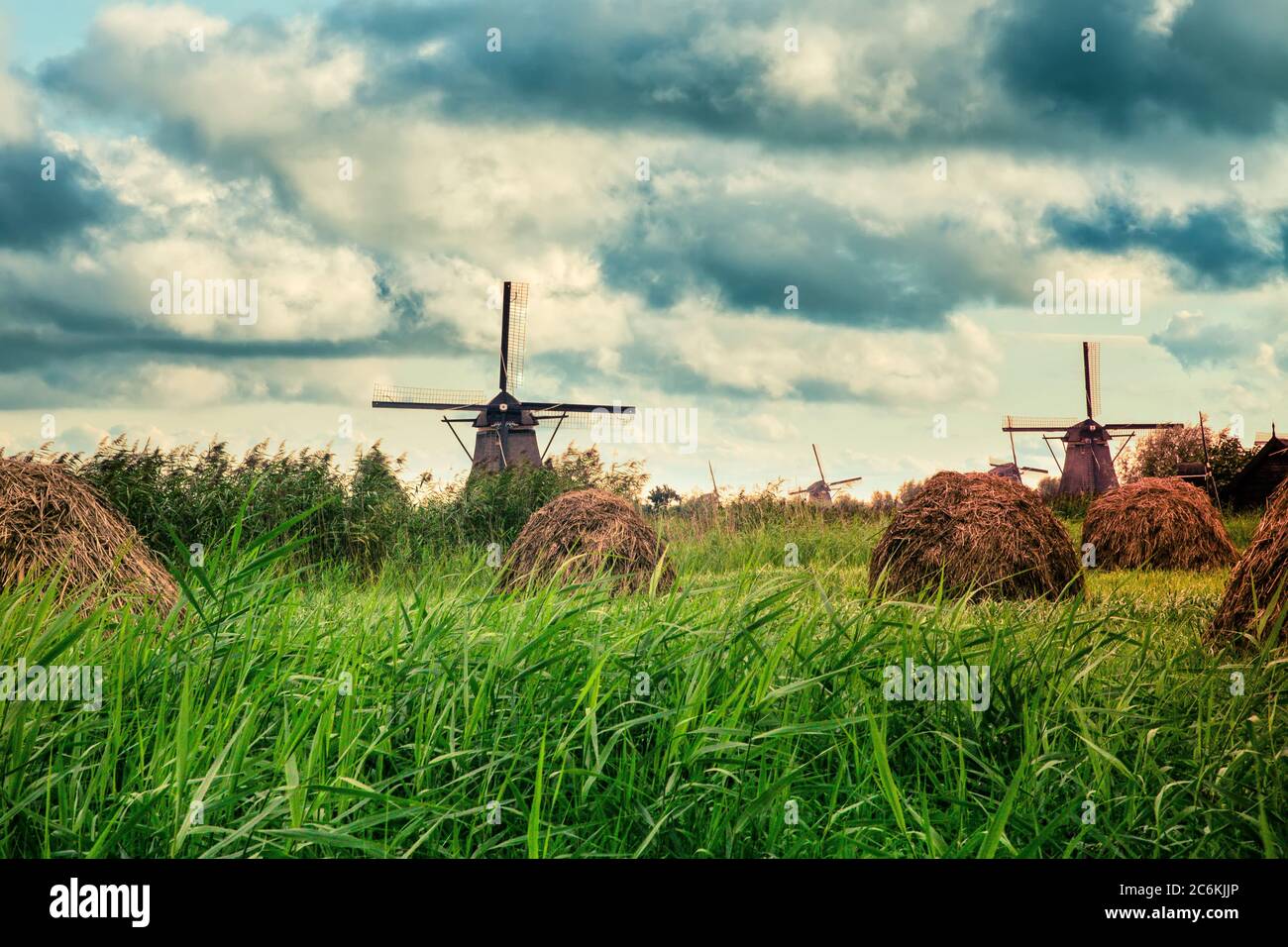 Beautiful Dutch windmills and landscape under dramatic sky Stock Photo