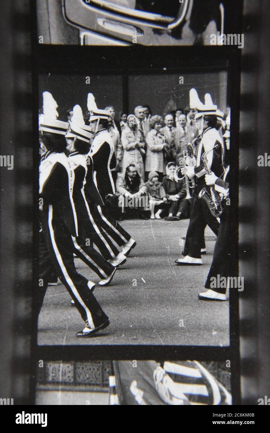Fine 70s vintage contact print black and white photography of high school students marching in a downtown Chicago parade. Stock Photo
