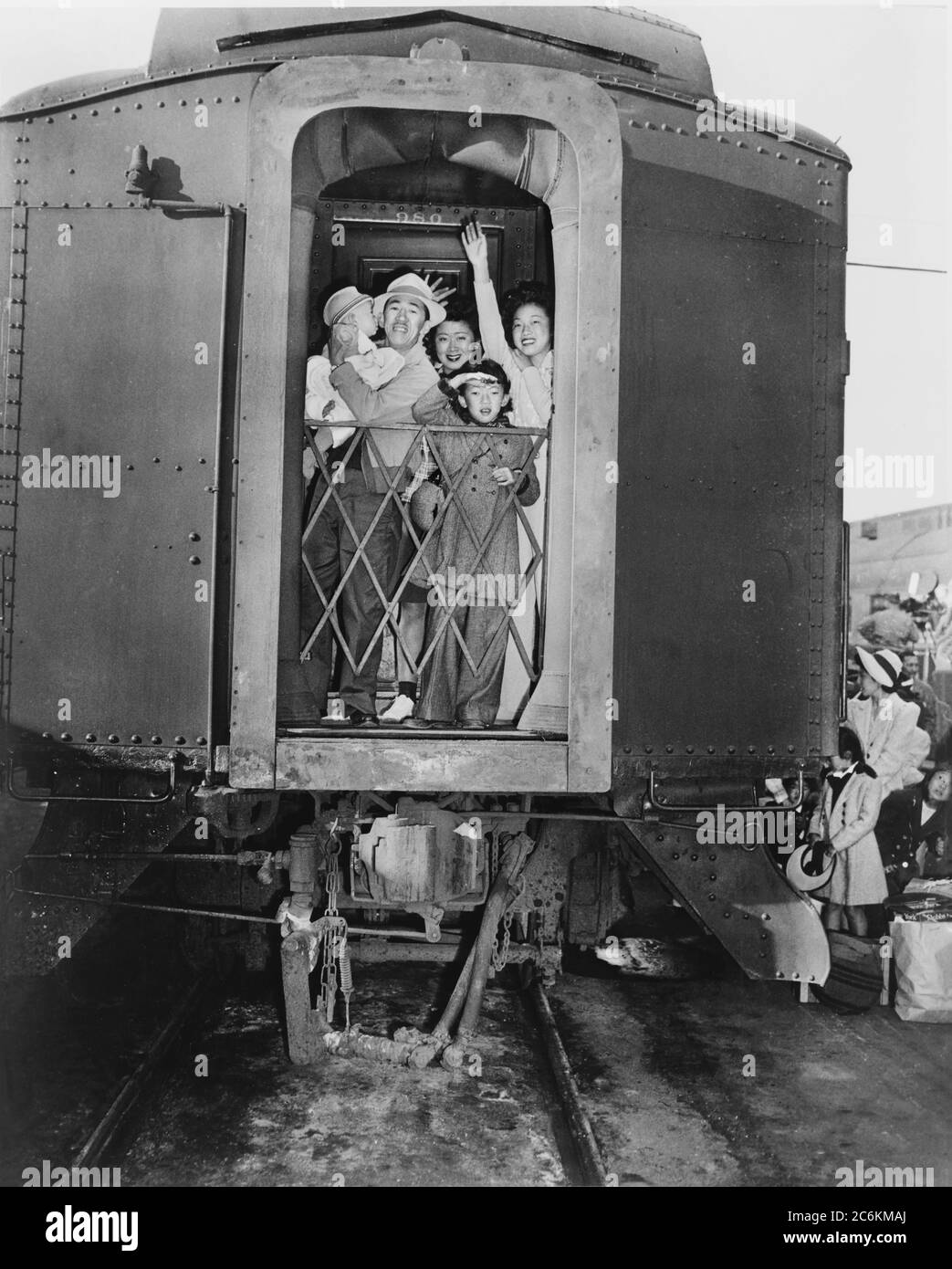 Group of Evacuees of Japanese Ancestry wave good-bye from rear of Train, Los Angeles, California, USA, U.S. Army Signal Corps, 1942 Stock Photo