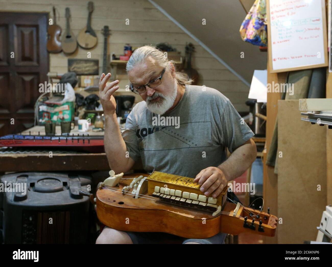 KRASNOYARSK TERRITORY, RUSSIA - JULY 4, 2020: Musical instrument maker  Mariss Jansons, 57, a follower of the Church of the Last Testament  religious movement, in his workshop in the Siberian village of
