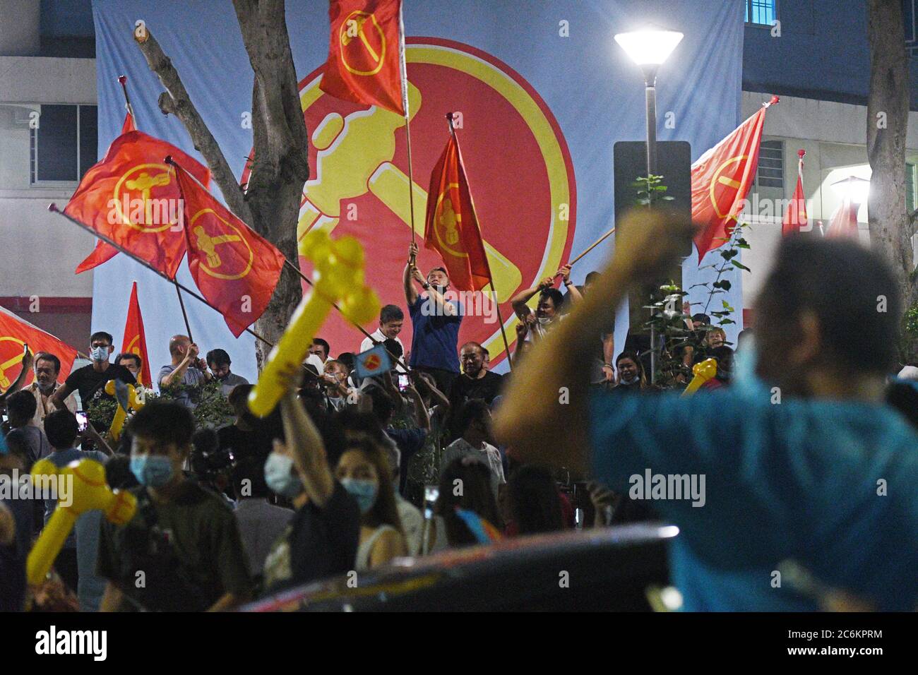 Singapore. 11th July, 2020. Supporters of Singapore's Workers' Party are seen in Singapore, on July 11, 2020. Singapore's ruling People's Action Party (PAP) won 83 of the 93 parliamentary seats in Singapore's general election, Returning Officer Tan Meng Dui said on Saturday. The Workers' Party (WP), which got six seats in the 2015 election, won 10 seats this year. Credit: Then Chih Wey/Xinhua/Alamy Live News Stock Photo