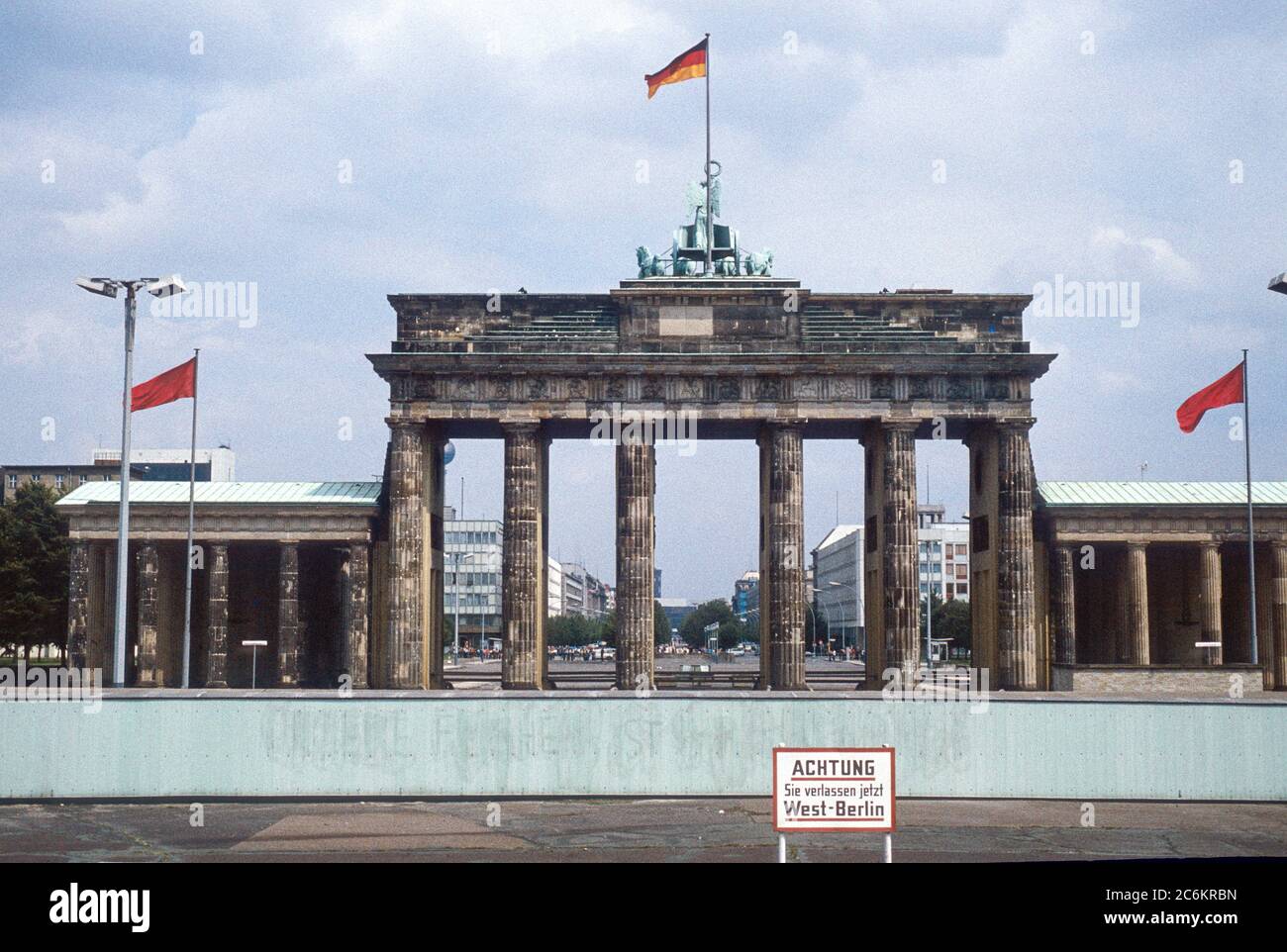 Historic image from July 1980: A look from West Berlin over the Berlin wall to Brandenburg Gate and East Berlin. Sign with 'Caution: You are leaving W Stock Photo