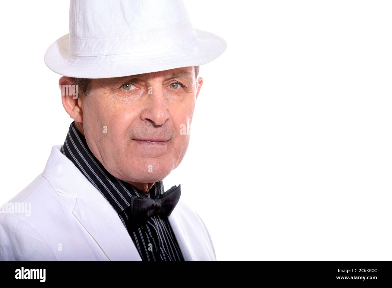 Attractive elderly man dressed in white with hat and elegant style Stock Photo