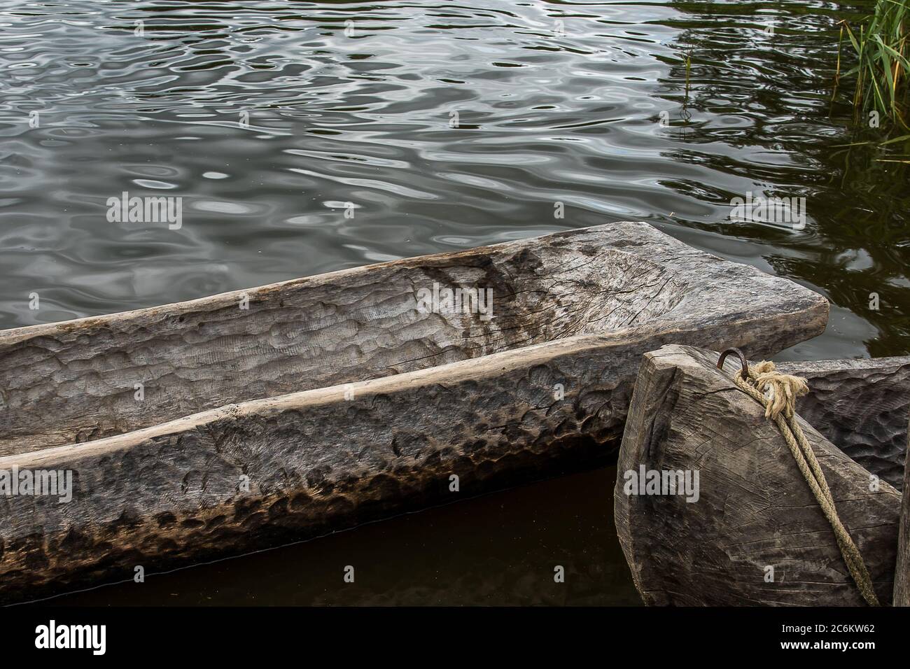 closeup of two dugout canoes made of old oak tree lying in the