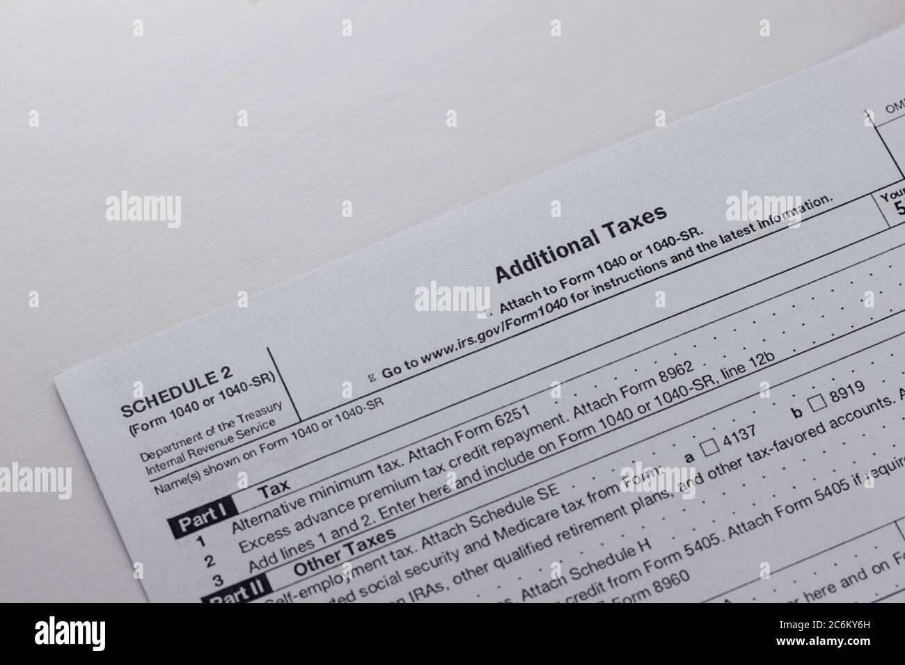 blank irs federal tax form schedule 2 for reporting additional taxes on a white background Stock Photo