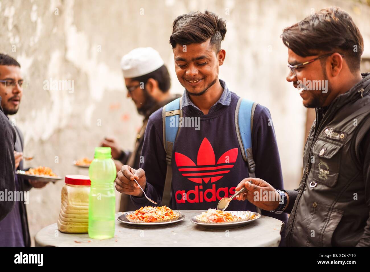 New Delhi / India - February 16, 2020: young students eating on the street next to university in Delhi Stock Photo