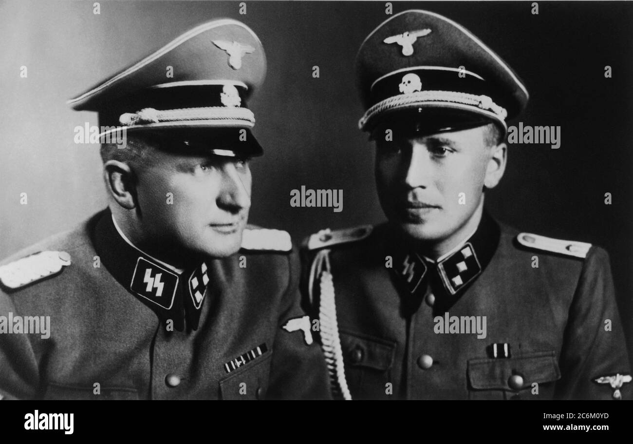1944, 21 june, AUSCHWITZ , POLAND : The Nazi German Concentration Camp, From left to right they are: RICHARD BAER ( 1911 - 1963 ) ( Commandant of Auschwitz ) and RUDOLF HOESS ( Höß , 1900 - 1947 ) the former Auschwitz Commandant .-  Konzentrationslager Auschwitz - Second World War - Shoà - OLOCAUSTO - EBREI - Campi di concentramento di sterminio ebraico - Ebrei - JEWISH - OLOCAUSTO - OLOCAUST - CRIMINALE DI GUERRA - criminali Nazisti - CRIMINALS - WWII - WORLD WAR 2nd - SECONDA GUERRA MONDIALE - WW2nd - WW2 - foto storiche - foto storica  - GERMANIA - POLONIA - HISTORY - FOTO STORICHE - NAZIST Stock Photo