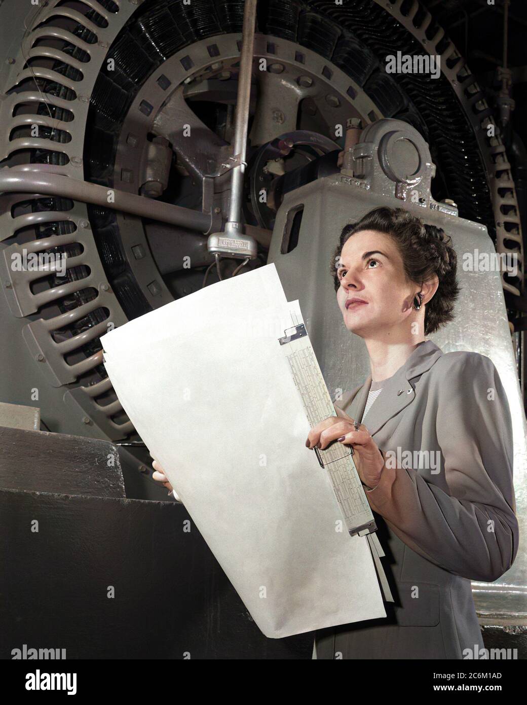 1952 , USA : The american Electrical Engineer woman KITTY Wingfield O'BRIEN JOYNER ( 1916 - 1993 ) of NASA ,  at work , expert in Electronics , at LANGLEY RESEARCH CENTER .  In this photo analyzing the operation of a wind tunnel turbine at NACA Langley in 1952 . Remembered like the first woman engineer at the Memorial Langley Aeronautical Laboratory . DIGITALLY COLORIZED .- NASA - N.A.S.A. - The National Aeronautics and Space Administration - foto storiche - foto storica  - scienziato - scientist  - INGEGNERE  DONNA  - INGEGNERIA ELETTRONICA - DONNE DONNA - AL LAVORO - AERONAUTICA --- Archivio Stock Photo