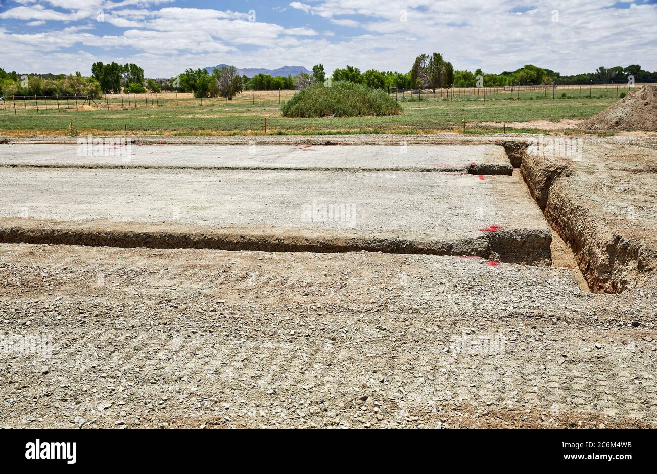 Level building site pad with three foot deep footing trench for a new building Stock Photo