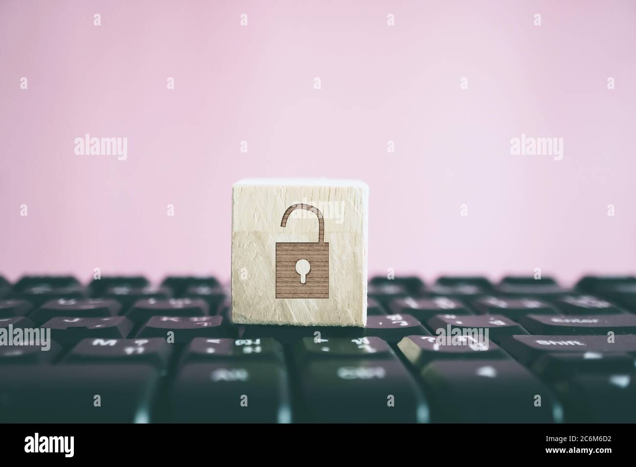 Closed up unlock icon as non security show on wood cube on computer ...