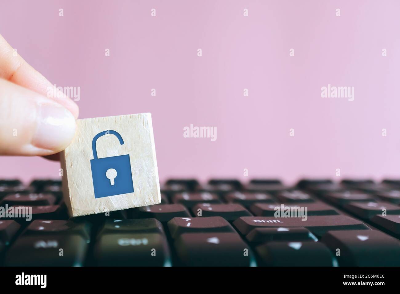 Closed up unlock icon as non security show on wood cube on computer ...