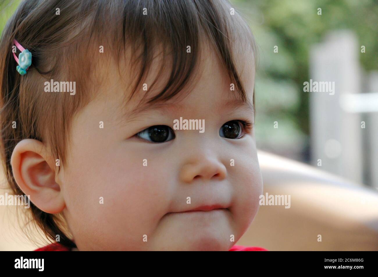 Close-up of beautiful baby Asian girl sucking her bottom lip Stock Photo -  Alamy