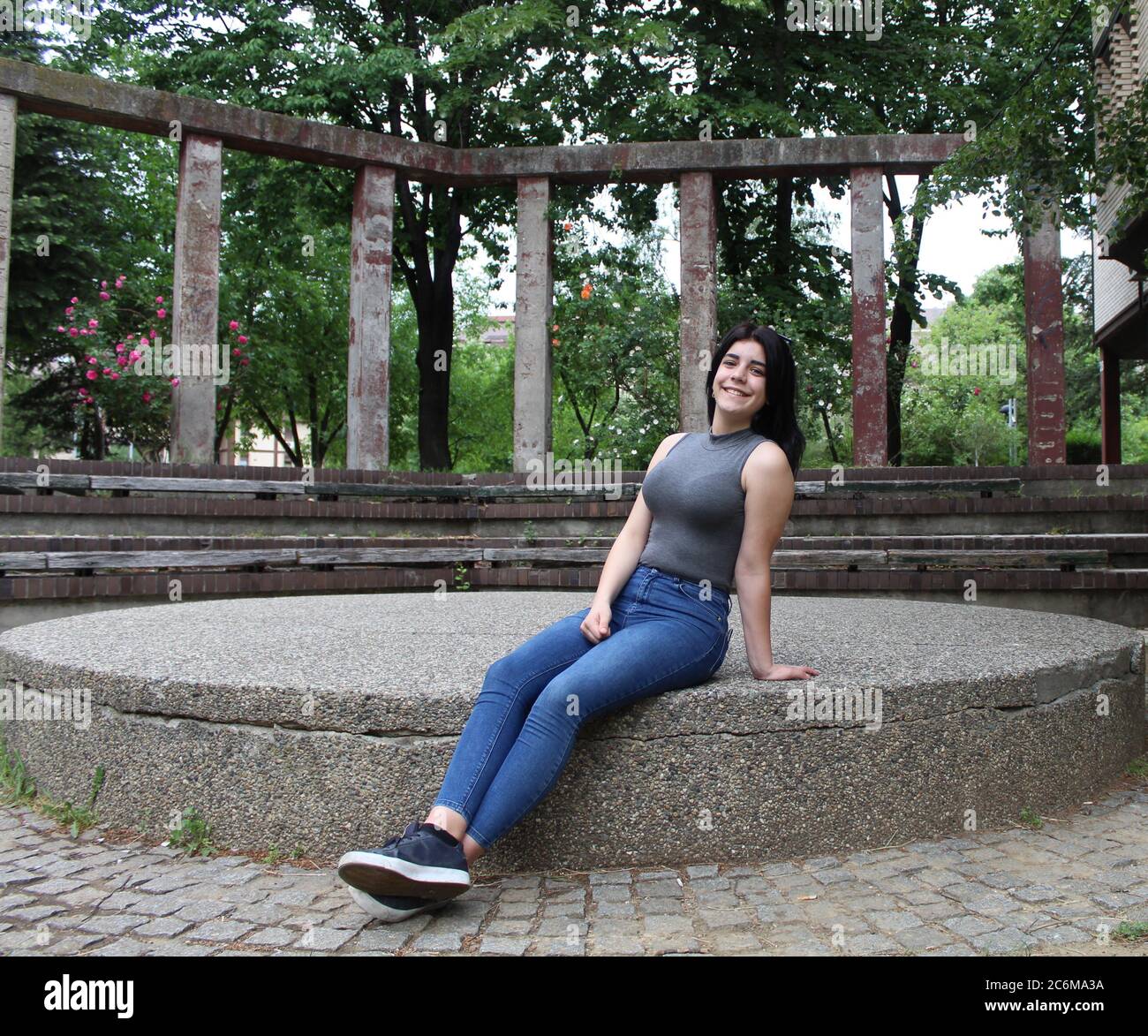 Young black-haired girl posing in the atrium Stock Photo