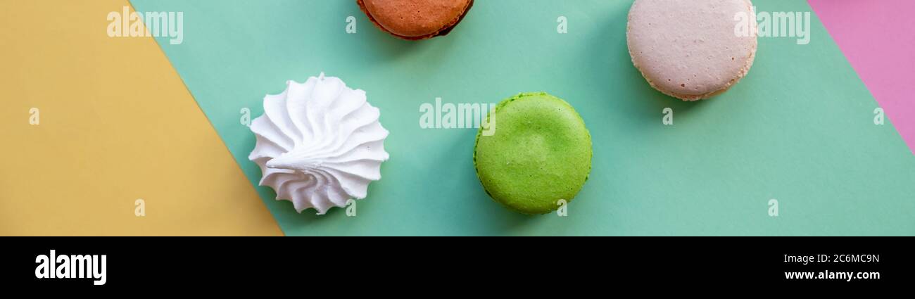flat lay of colorful unstable french macaroon cookies like background, dessert concept.Pop Art Color style with meringue and bakery goodies on bright Stock Photo