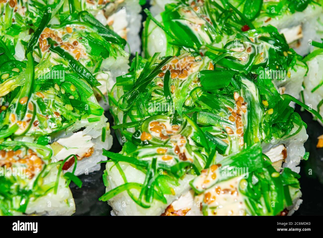 Rolls with fish, cheese and green algae. A traditional Japanese dish