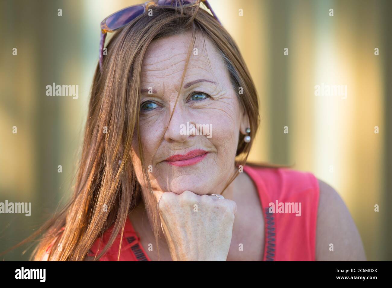 Portrait confident attractive mature woman, posing thoughtful, contemplating outdoor. Stock Photo