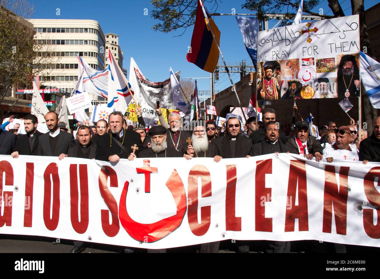 Christian priests holding a banner saying, ‘religious cleansing’ led ...