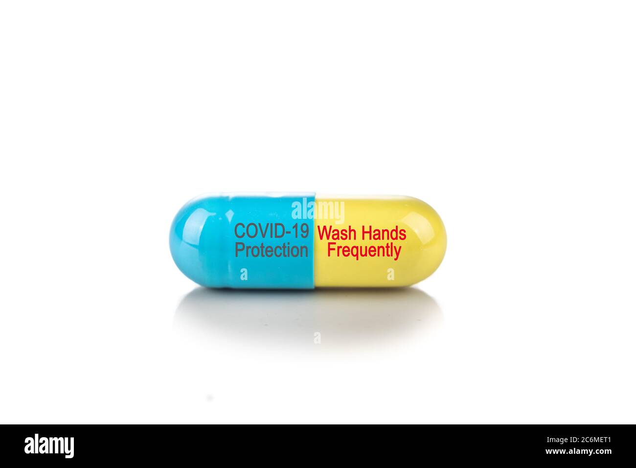 Conceptual Covid-19 protection capsule with Wash Hands Frequently advisory message on white background Stock Photo
