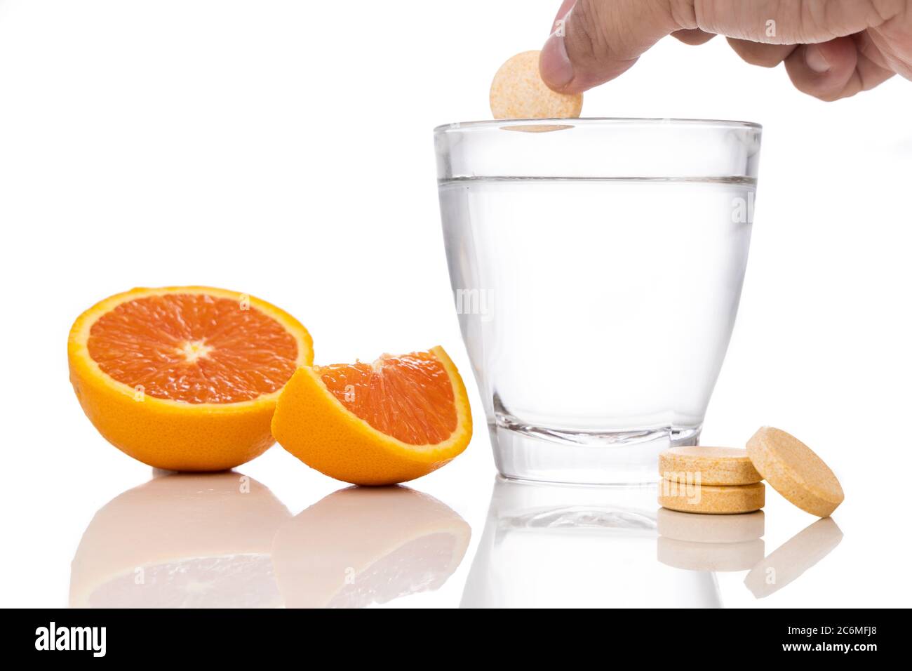 Series of orange flavored vitamin c effervescent tablet dropped and
