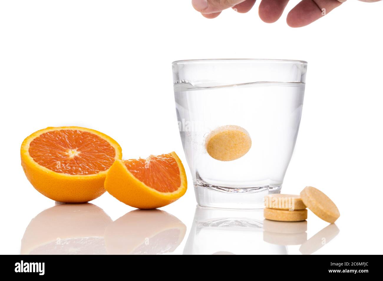 Series of orange flavored vitamin c effervescent tablet dropped and