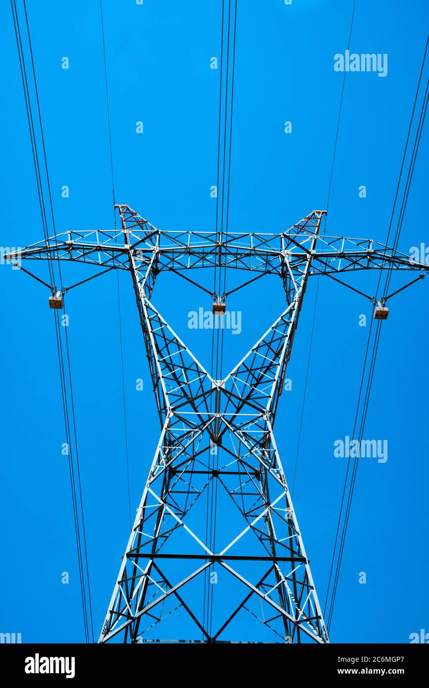 power line pylon with high voltage wires bottom up view opposite sky ...