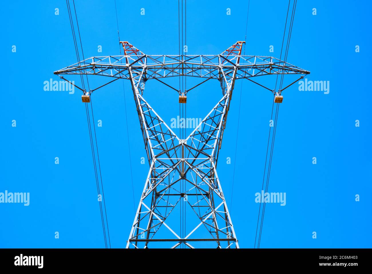 power line pylon with high voltage wires bottom up view opposite sky ...