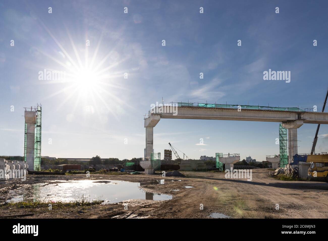 Construction of Mass Rail Transit column infrastructure in progress to improve transportation network, against bright sun ray Stock Photo