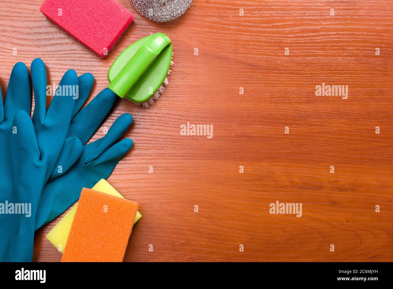 Set for cleaning various surfaces in the kitchen, bathroom and other areas. Copyspace for text or logo on a wooden background. The concept of cleaning services, house cleaning Flat lay Stock Photo
