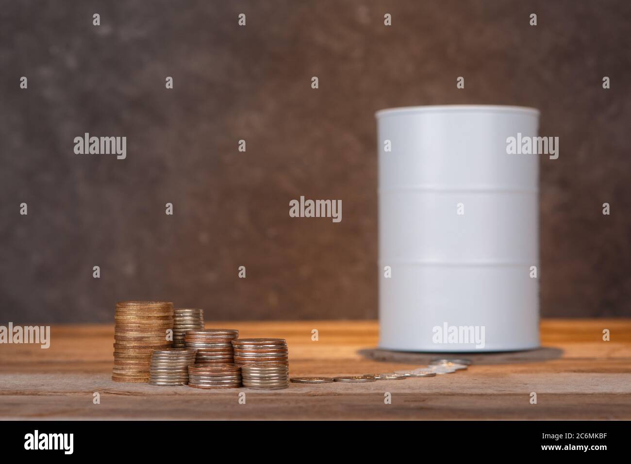investing in oil. Barrel of oil and coins Stock Photo
