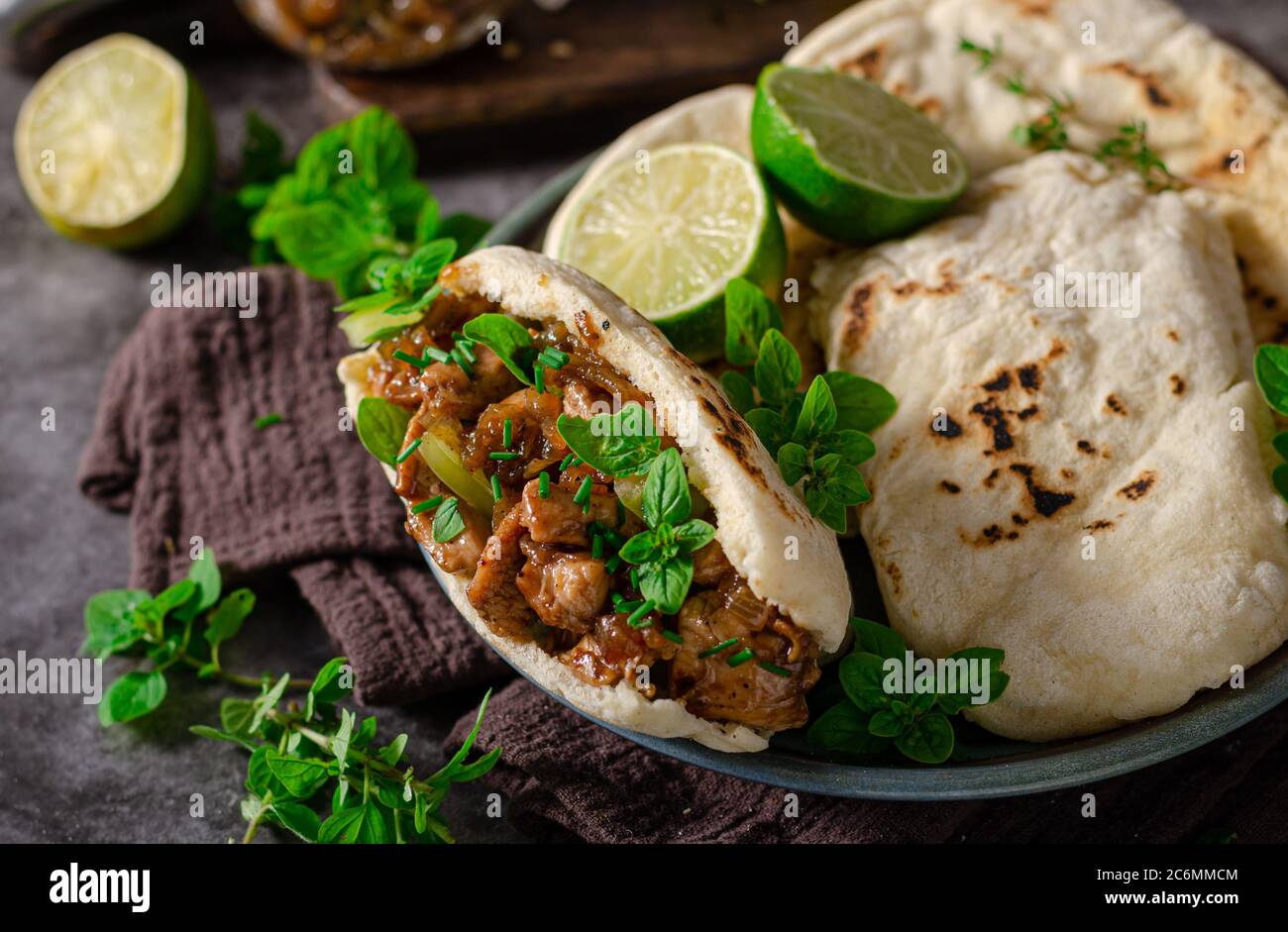 Delicious pita bread with meat, fresh herbs and caramelized onion Stock