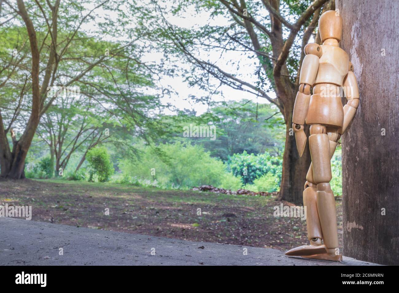 A Wooden Human Manikin relaxing outdoors, Ishasha, Uganda, Africa Stock