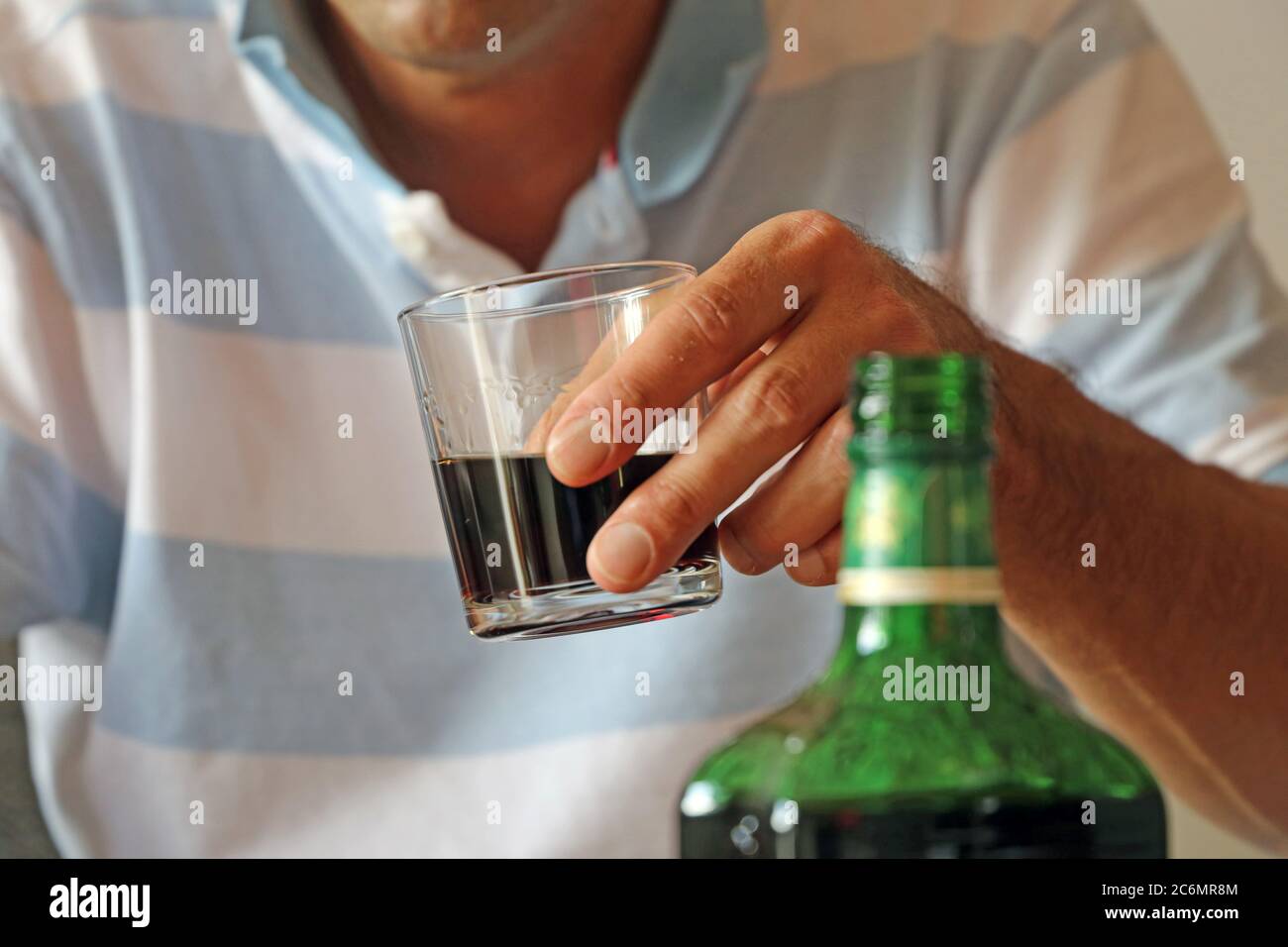 Symbol image: Man with drinking problems at home (Model released) Stock Photo