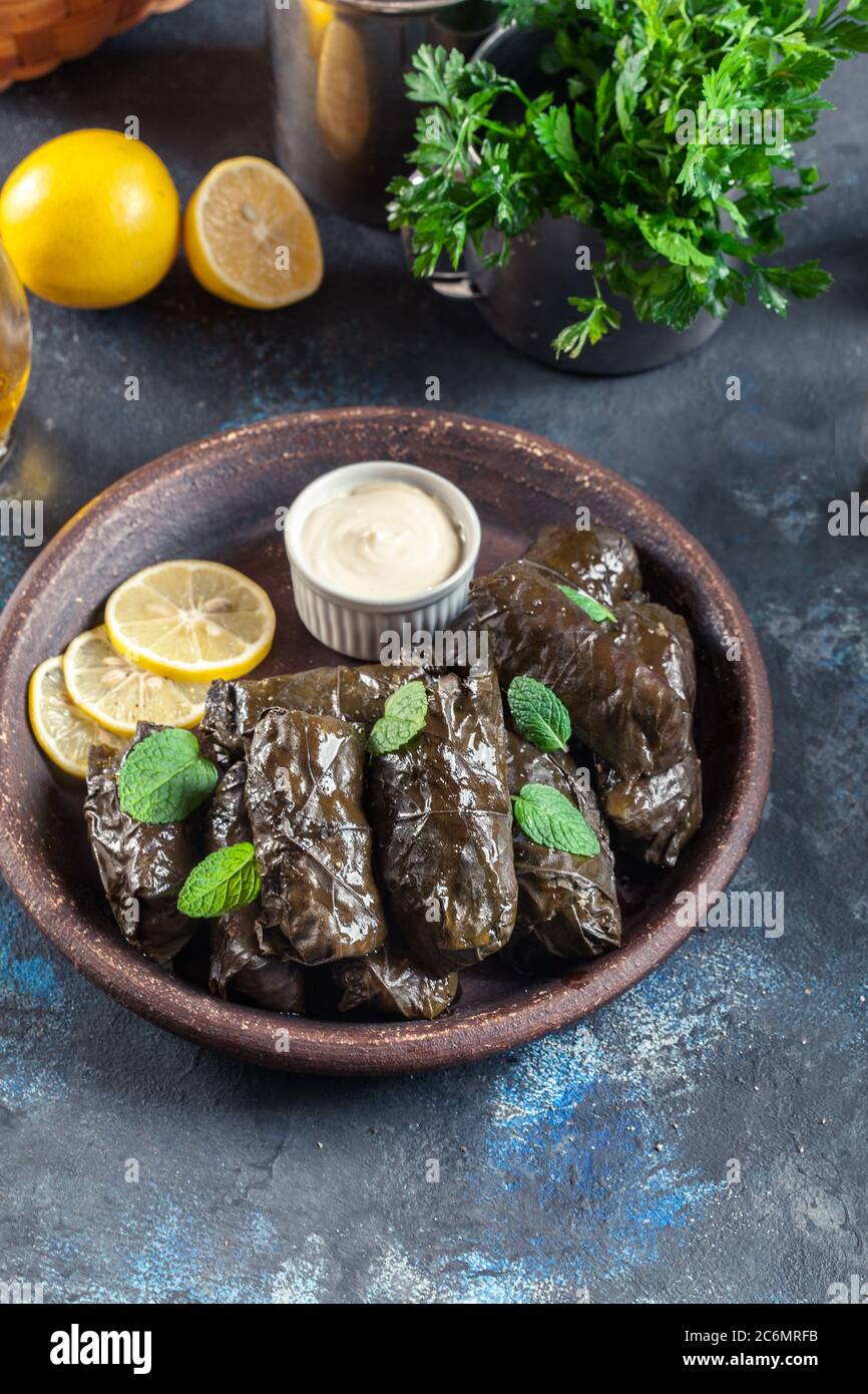 Traditional greek cuisine. Wrapped rice in grape leaves. Dolma with lemon and spices. Home