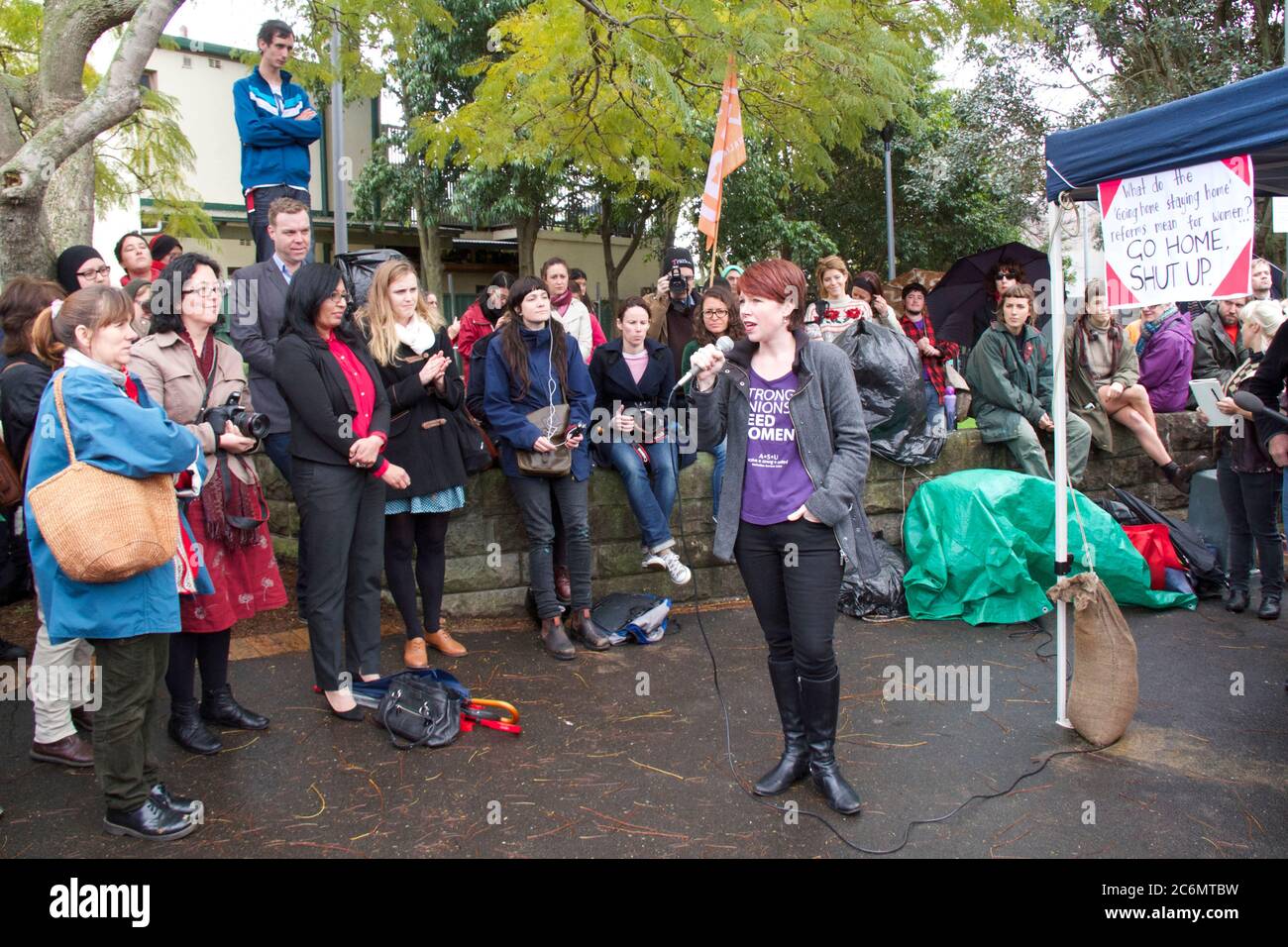 A speaker addresses the rally to save women’s refuges from closure at Minogue Reserve, Glebe in Sydney. Stock Photo