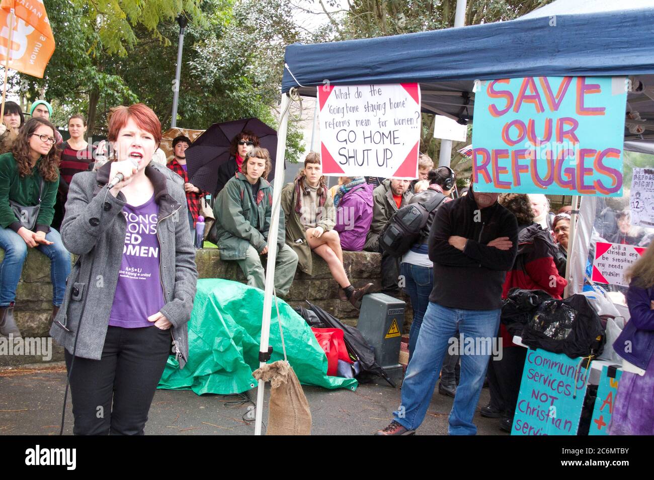 A speaker addresses the rally to save women’s refuges from closure at Minogue Reserve, Glebe in Sydney. Stock Photo