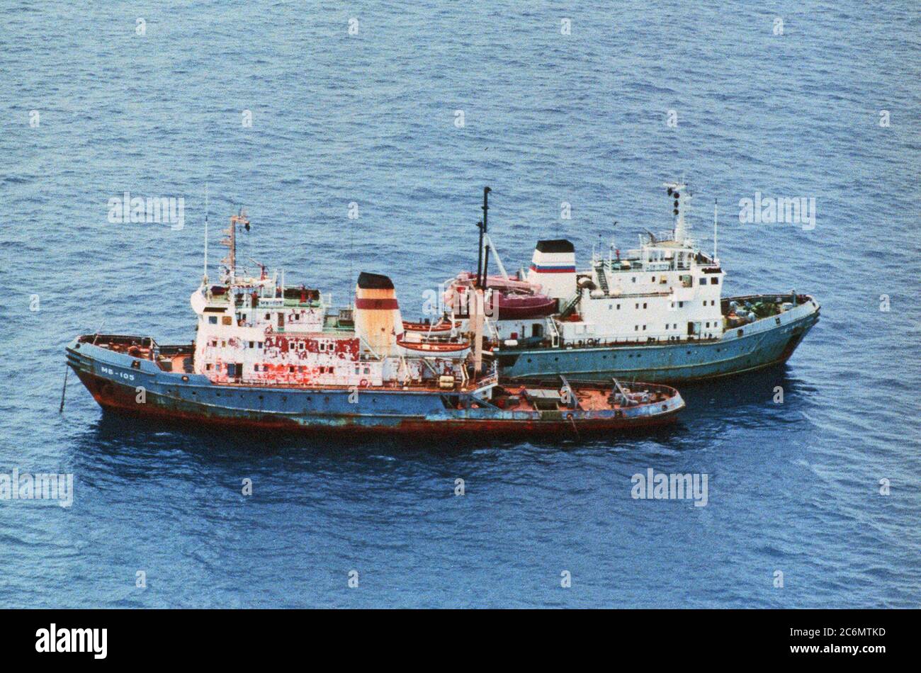 Aerial port side view of the Russian Navy Pacific Fleet Goryn class rescue tug SB-522 operating along side her sister ship ocean going tug MB-105. Stock Photo