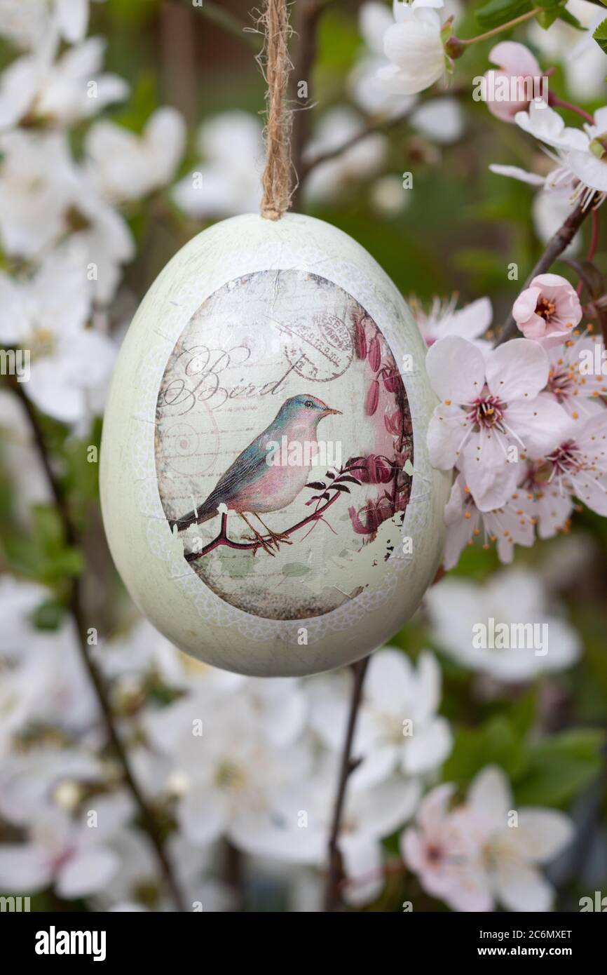 easter egg with bird ornament and bloomong branches as easter decoration Stock Photo