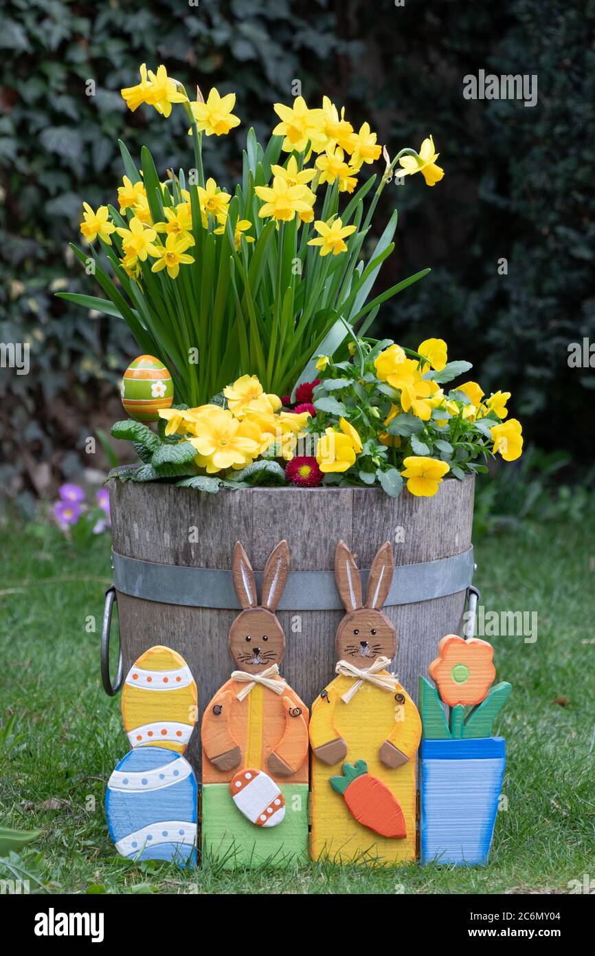 easter decoration spring flowers in yellow and easter bunnies Stock Photo