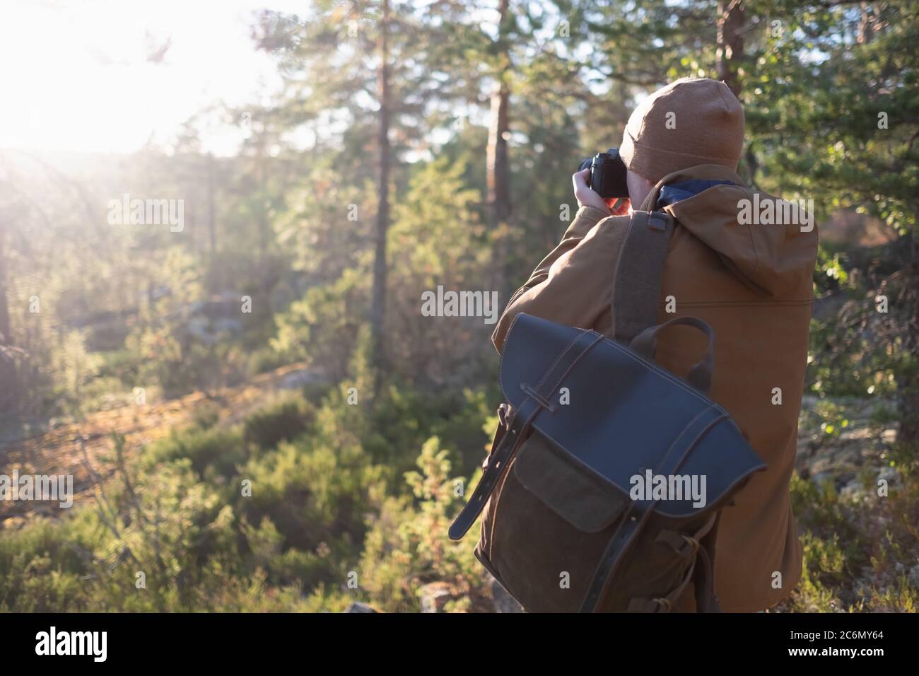 Photographer with camera photographing the forest view Stock Photo - Alamy