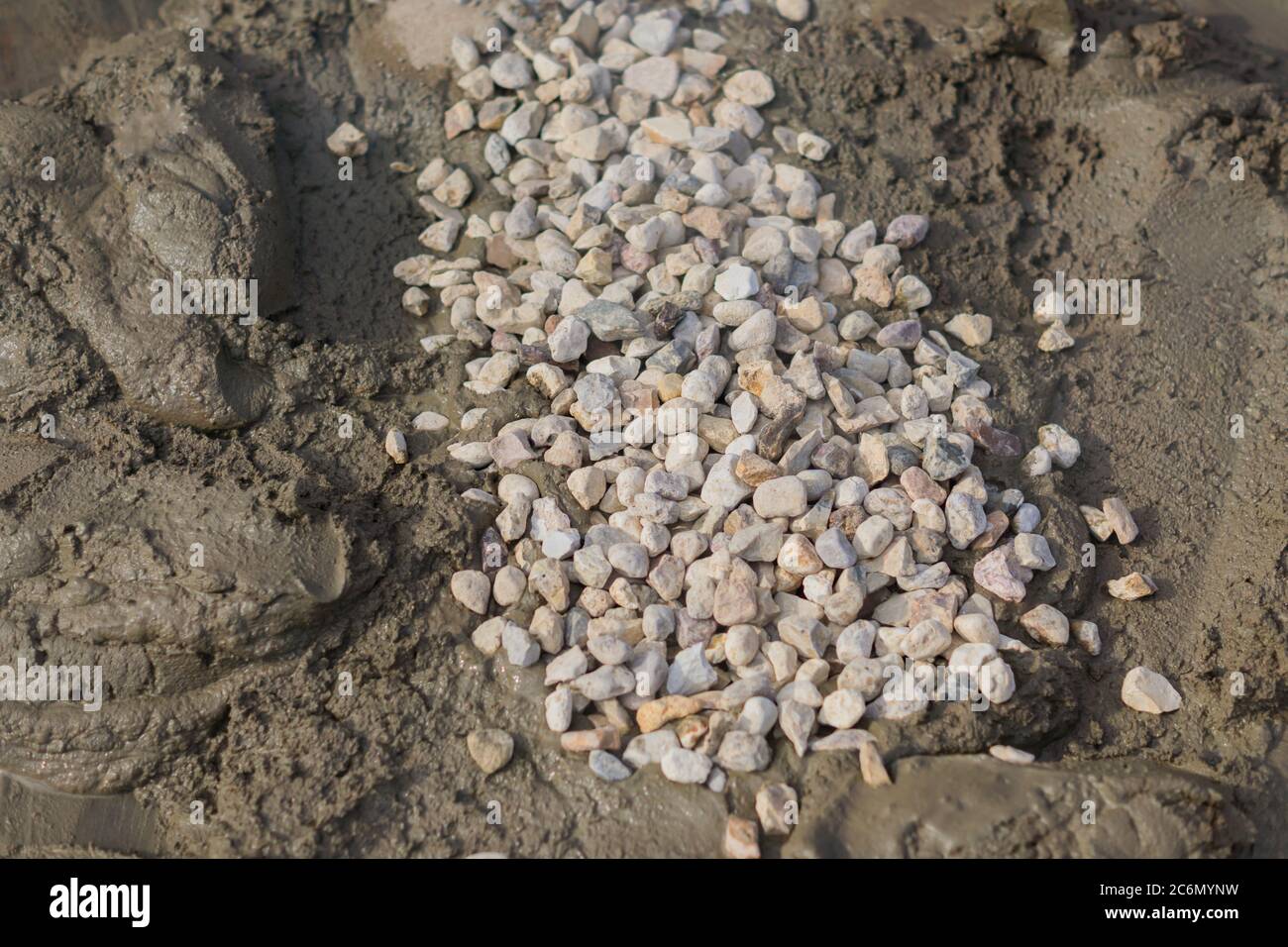 mixing concrete with gravel on construction cite Stock Photo Alamy
